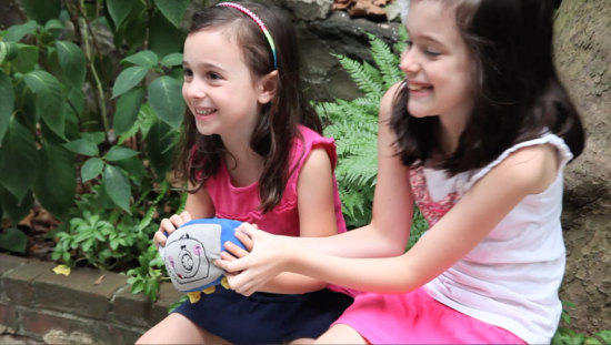 Girls enjoying their Walter the Vault plush toys during the video shoot